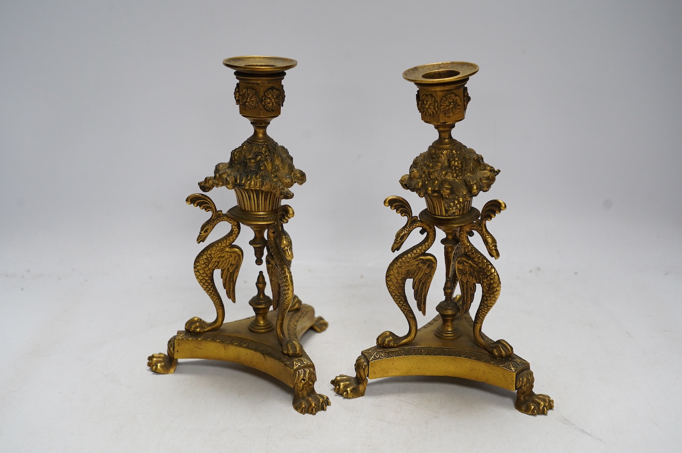 A pair of Empire style ormolu candlesticks, 20cm. Condition - fair to good